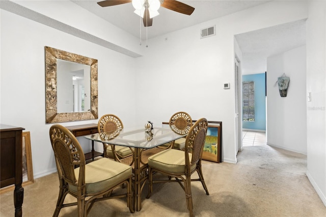 carpeted dining space featuring ceiling fan