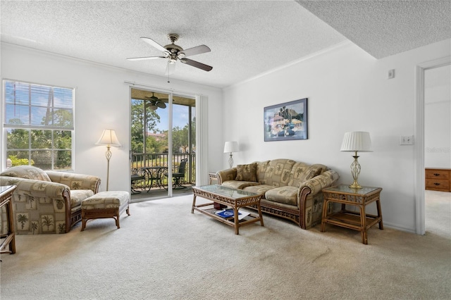 living room with a textured ceiling, carpet flooring, plenty of natural light, and ceiling fan