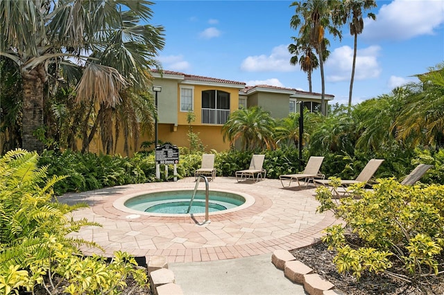 view of pool featuring an in ground hot tub and a patio