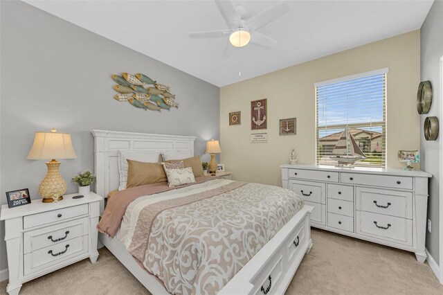 bedroom featuring light carpet and ceiling fan