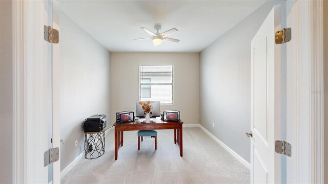 carpeted office space featuring ceiling fan