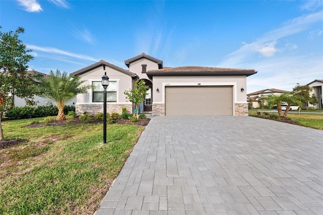 view of front facade featuring an attached garage, stone siding, decorative driveway, and stucco siding