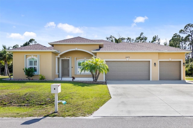 view of front facade with a garage and a front lawn