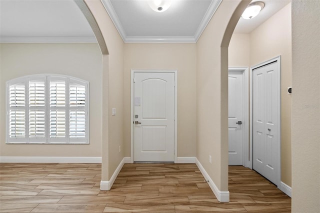 foyer with light hardwood / wood-style floors and ornamental molding