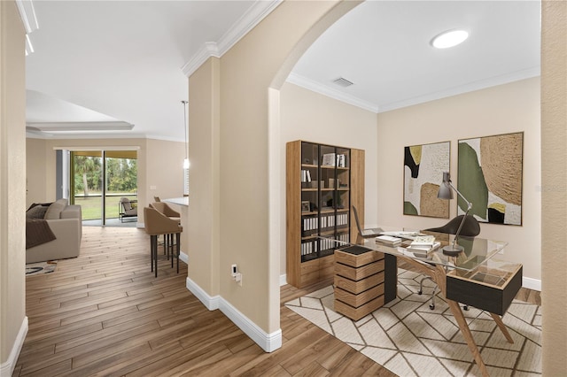 office with crown molding and light hardwood / wood-style floors