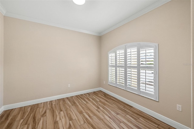 empty room featuring light hardwood / wood-style flooring and ornamental molding