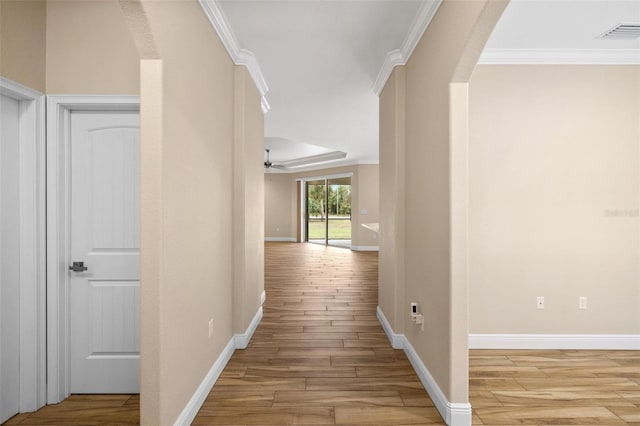 hall featuring light hardwood / wood-style flooring and ornamental molding