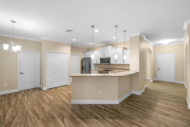 kitchen featuring kitchen peninsula, pendant lighting, white cabinetry, and stainless steel appliances