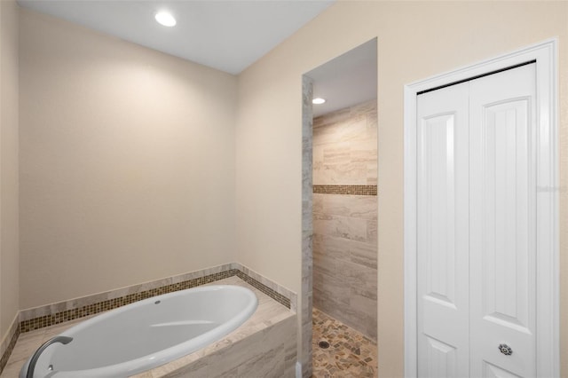 bathroom with shower with separate bathtub