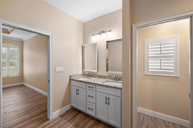 bathroom featuring hardwood / wood-style flooring, vanity, and ornamental molding