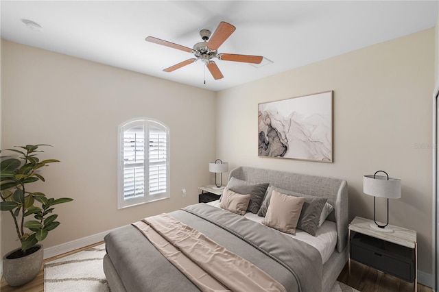 bedroom with ceiling fan and hardwood / wood-style flooring