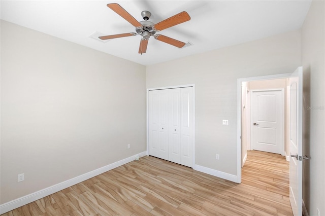 unfurnished bedroom with ceiling fan, a closet, and light wood-type flooring