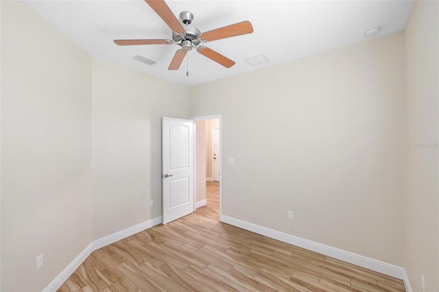 empty room with ceiling fan and light wood-type flooring