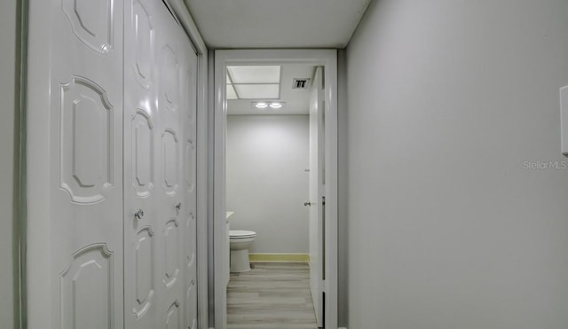 bathroom featuring wood finished floors, visible vents, baseboards, a closet, and toilet