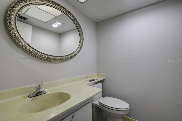 bathroom featuring toilet and vanity