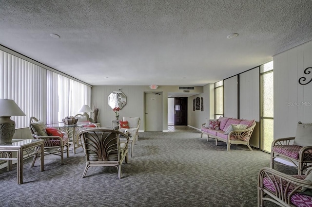 carpeted living room with visible vents and a textured ceiling