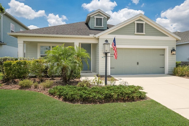 view of front of property with a front lawn and a garage