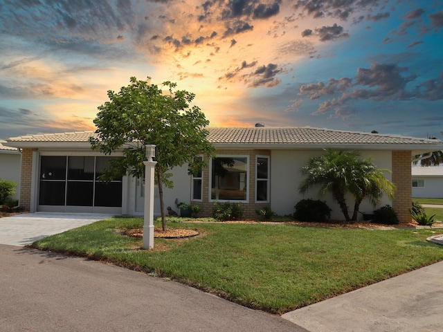 view of front facade with a yard and a garage