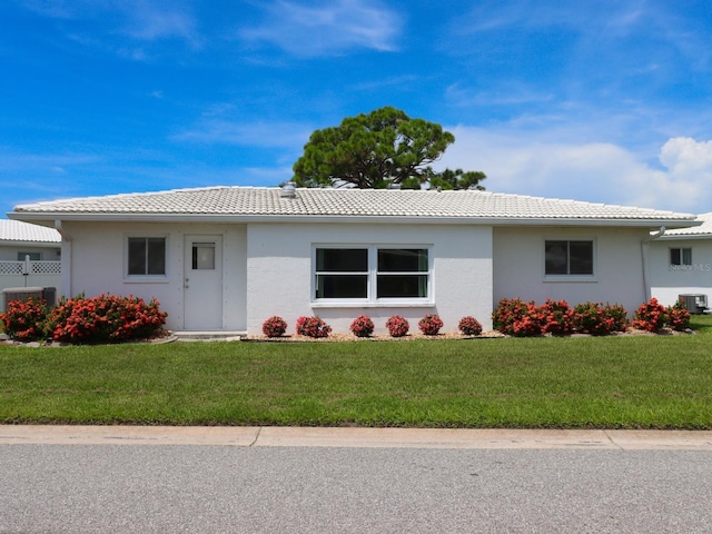 ranch-style house featuring central AC and a front lawn