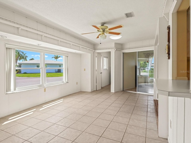 interior space featuring ceiling fan and a textured ceiling