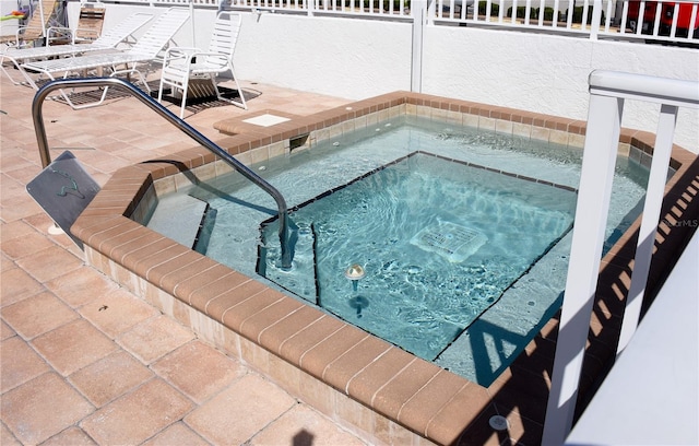 view of pool with an in ground hot tub