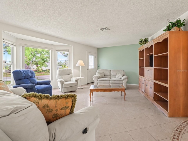 tiled living room featuring a textured ceiling