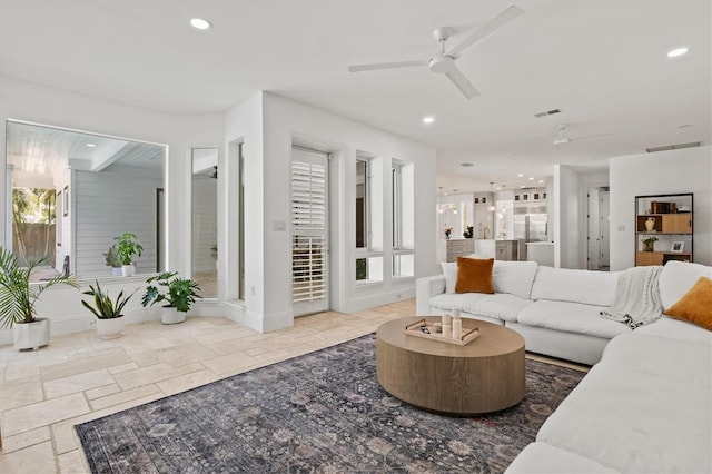 living room with a wealth of natural light and ceiling fan