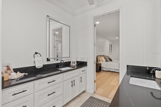 bathroom featuring crown molding, vanity, and hardwood / wood-style flooring