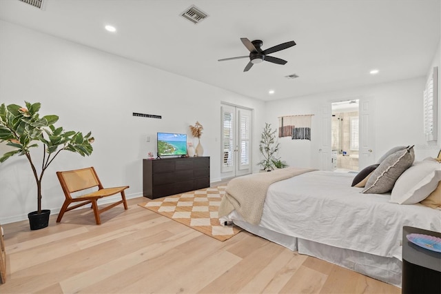 bedroom with ensuite bath, ceiling fan, and light hardwood / wood-style floors