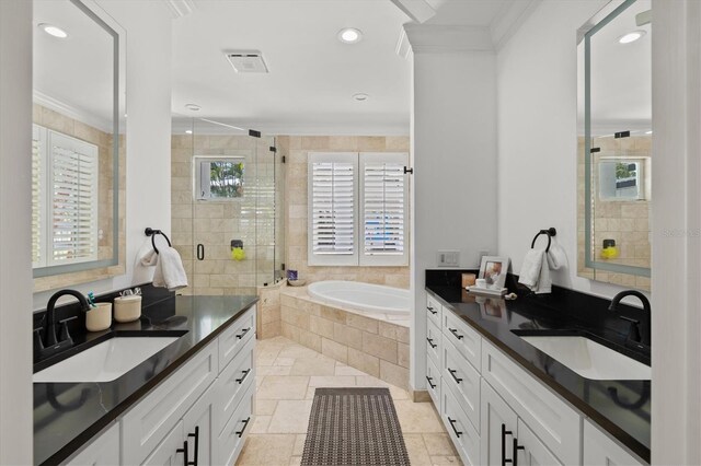 bathroom featuring vanity, independent shower and bath, and ornamental molding