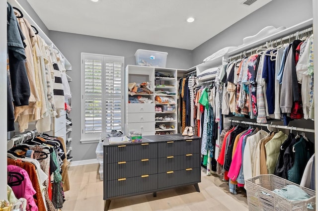 walk in closet featuring light hardwood / wood-style flooring