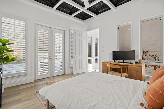 bedroom with beam ceiling, access to exterior, light hardwood / wood-style floors, and coffered ceiling