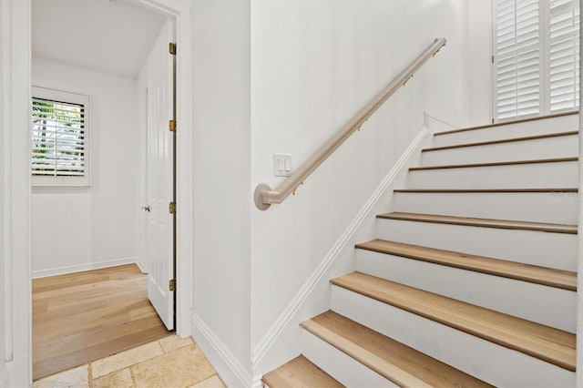 stairs featuring wood-type flooring