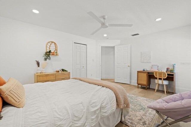 bedroom with ceiling fan, light wood-type flooring, and a closet