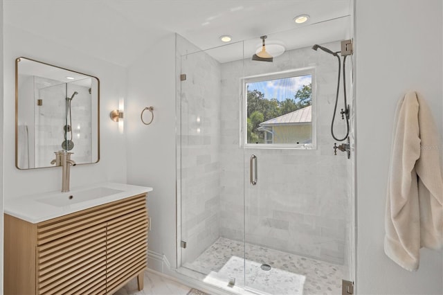 bathroom featuring vanity and a shower with shower door