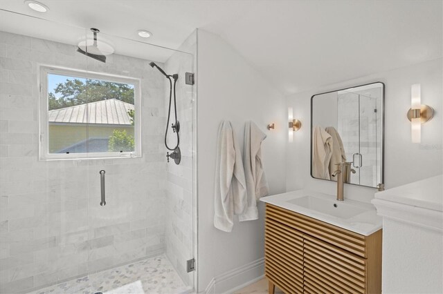 bathroom featuring vanity and a shower with shower door