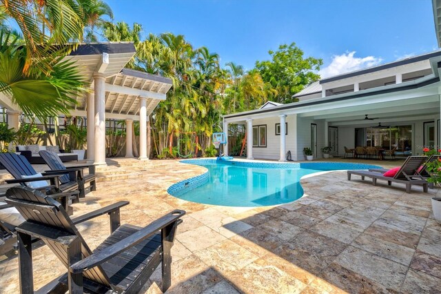 view of swimming pool with a patio area and ceiling fan