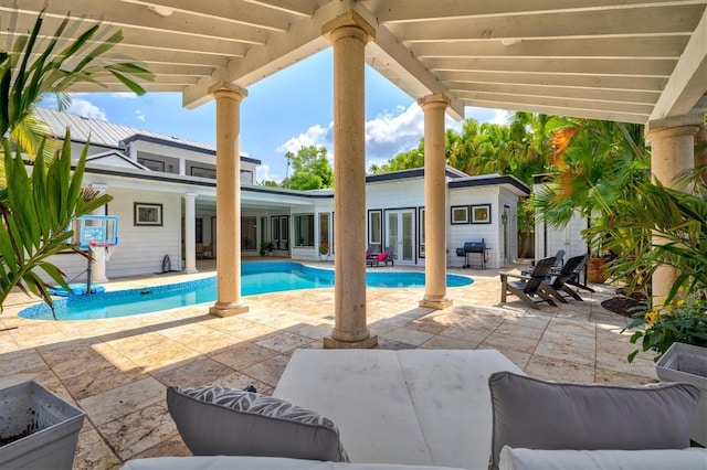 view of pool featuring grilling area, french doors, and a patio