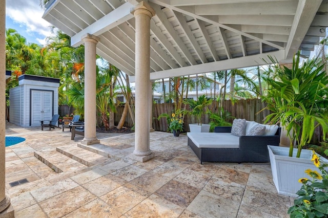 view of patio / terrace with an outdoor living space and a storage shed