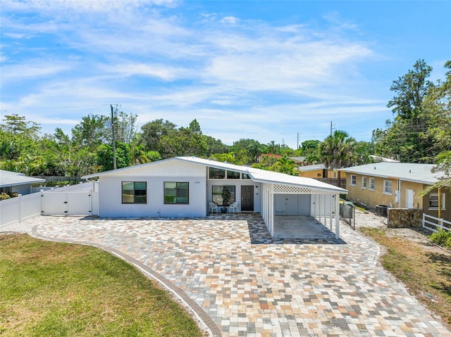 view of front of home with a patio area, fence, a gate, and central air condition unit