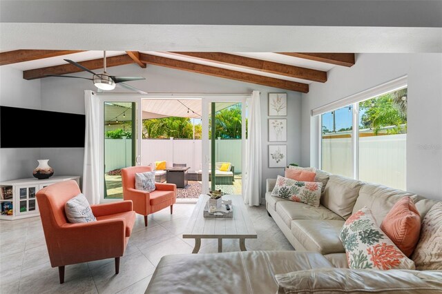 living room featuring ceiling fan, light tile patterned floors, and lofted ceiling with beams