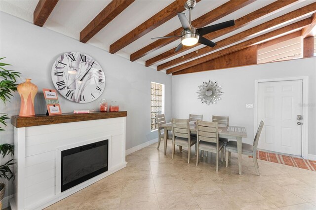 dining space featuring ceiling fan and vaulted ceiling with beams