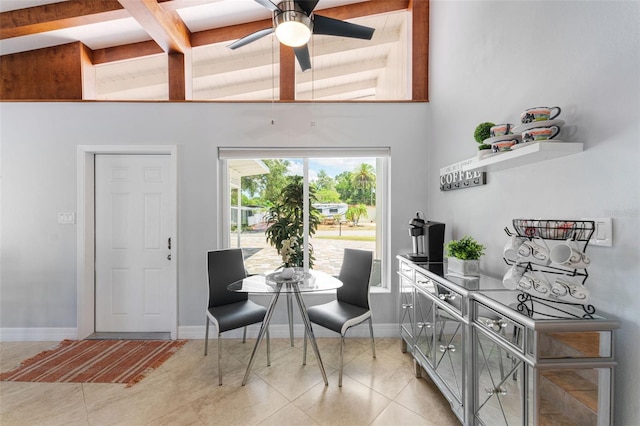 tiled dining space featuring ceiling fan, high vaulted ceiling, and beamed ceiling