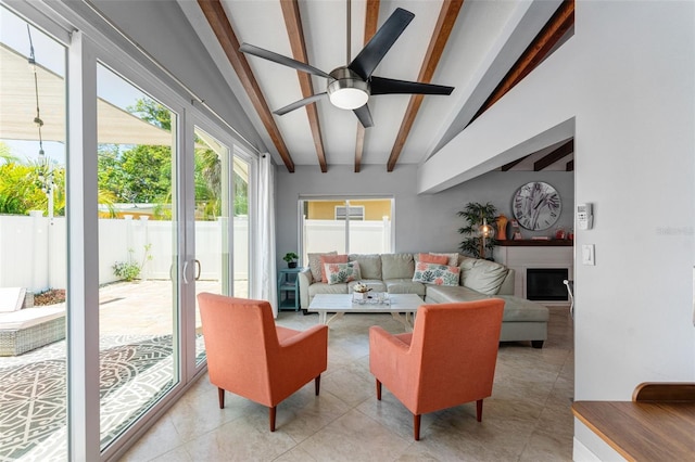 sunroom / solarium with ceiling fan and lofted ceiling with beams