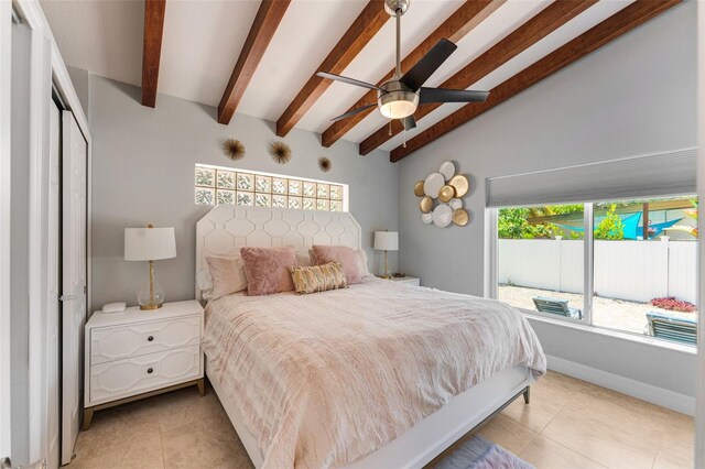 bedroom with ceiling fan, light tile patterned floors, a closet, and lofted ceiling with beams