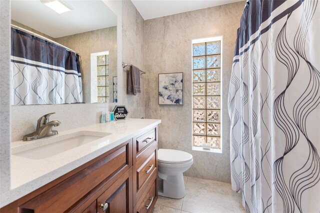 bathroom featuring toilet, vanity, and tile patterned floors