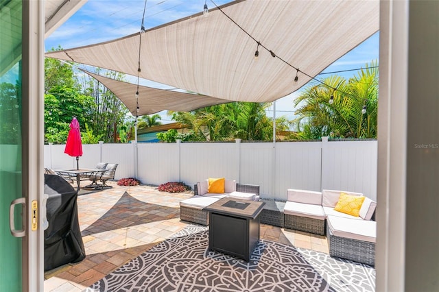 view of patio featuring an outdoor living space with a fire pit