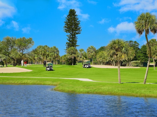 view of community featuring a yard and a water view