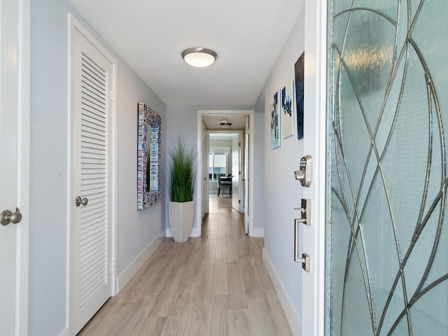 corridor with light hardwood / wood-style flooring