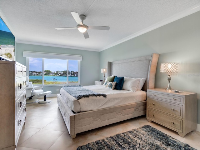 tiled bedroom with a textured ceiling, ceiling fan, a water view, and crown molding